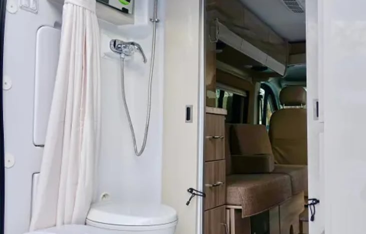 Full bathroom with cassette toilet, fold down sink with mirror and shower.