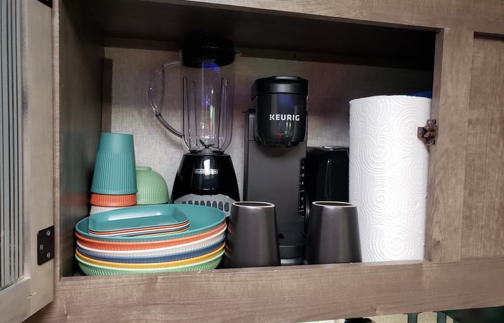 The kitchen comes FULLY stocked w/ a blender, toaster, Keurig coffee maker, plates, cups, and bowls