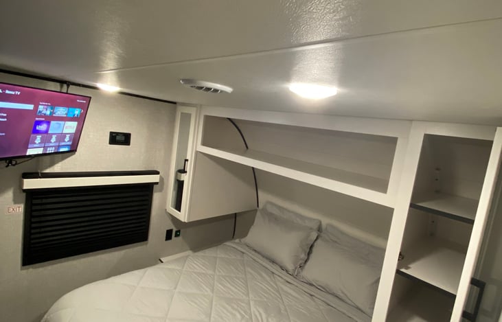 Queen master bed with memory foam topper and Roku TV.