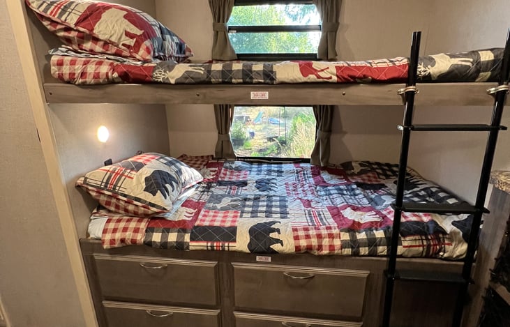 Bunk beds with ladder to access top bunk.