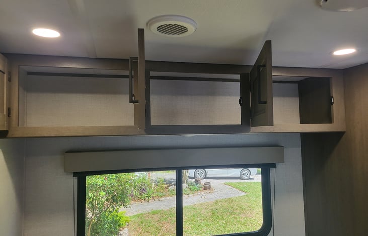 Large storage cabinets above the fold out sofa. Great for guest's clothing and other belongings.