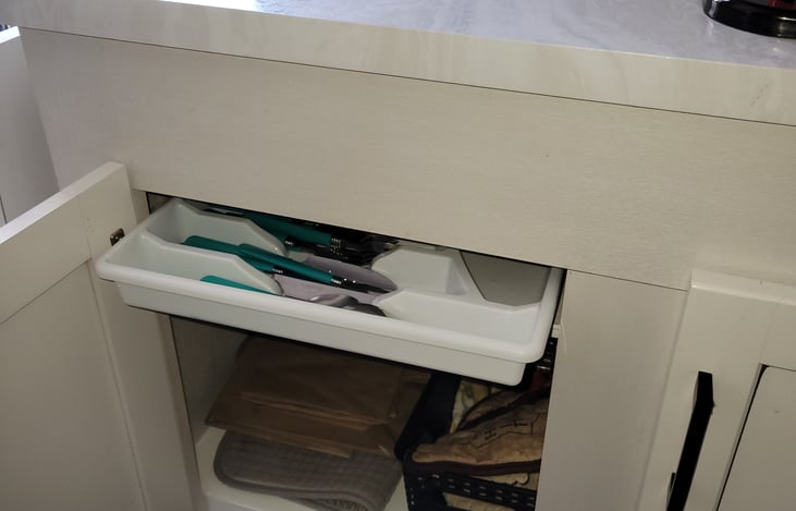 Under sink- silverware, pot holders, cooking pans