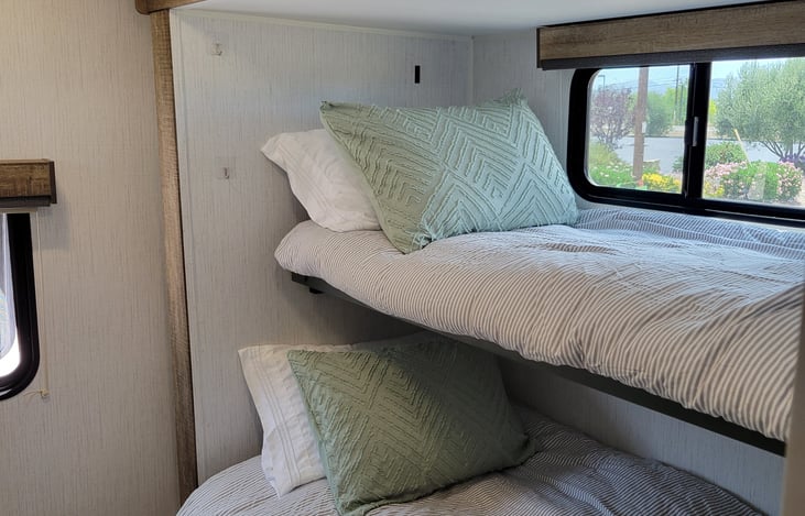 Bottom is a Jack knife couch conversion bed
top is a bunk that folds up when not in use.