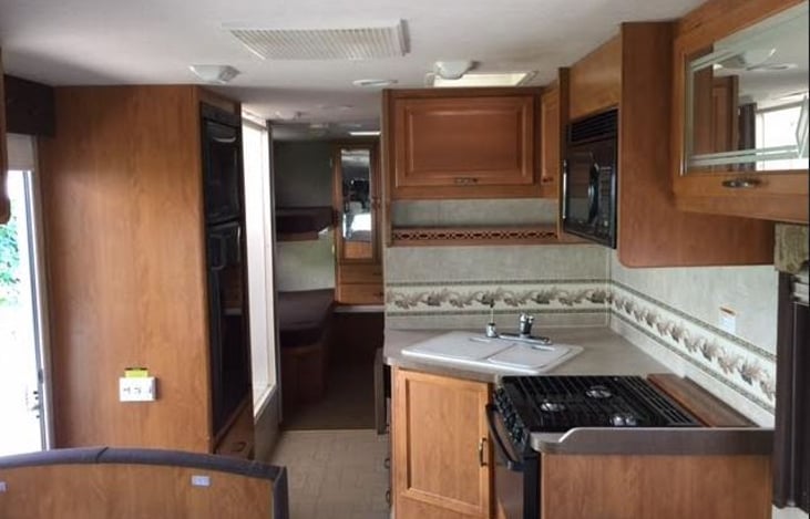 large kitchen with 3 burner stove , oven, microwave, and more
