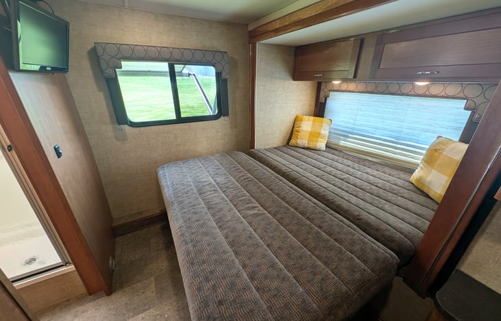 Cozy queen bed in the back with a slide-out closet and plenty of storage.