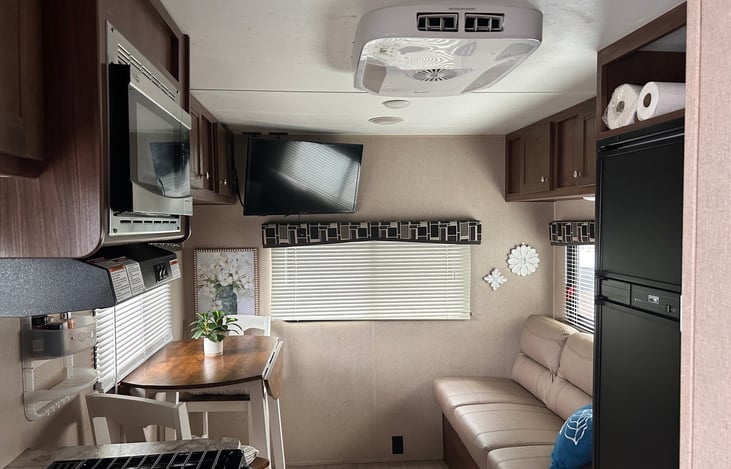 Living space has couch, table and TV (Amazon Fire Stick TV)