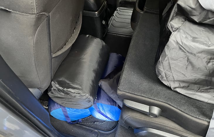 When setting up the bed, toss the sleeping bags, camp pillow pack and privacy curtain pack on the floor behind the front seats.