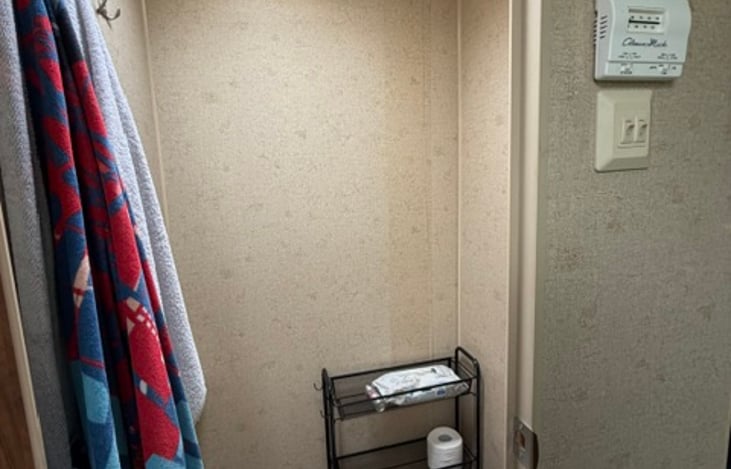 Bathroom with toilet area separate from the sink and shower.