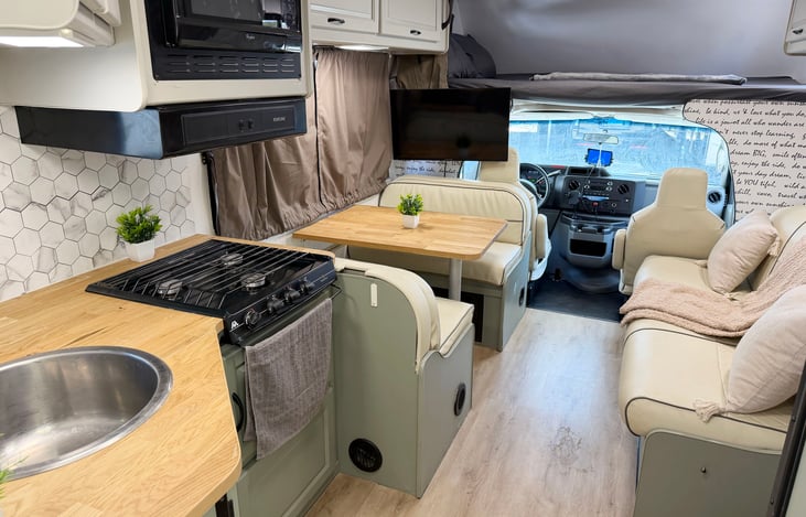 Clean, fully equipped RV kitchen & living area – ideal Las Vegas RV rental for festivals and camping