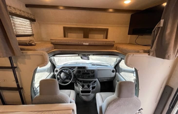 Over cab sleeping area with the bunk folded over. This allows room for driver or companion to stand to access the rear of the camper.
