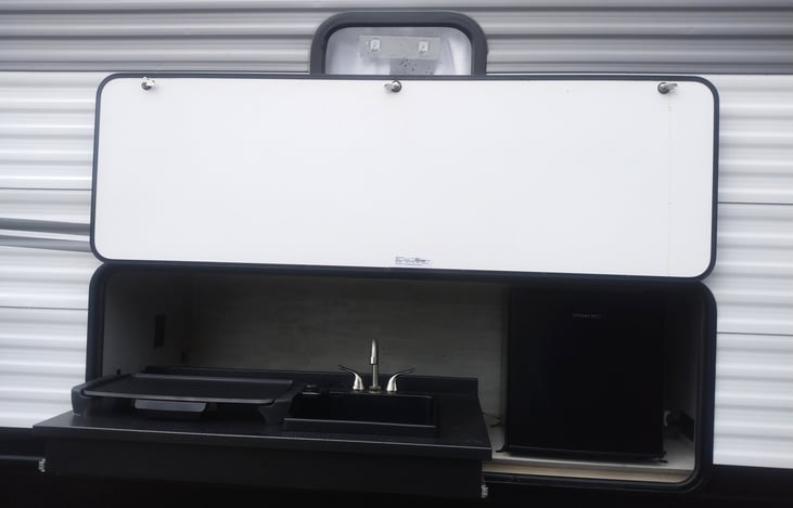 Outside Kitchen with sink, refrigerator and griddle