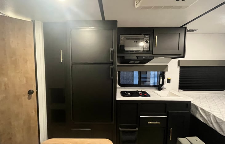 Spacious pantry located next to the fridge.