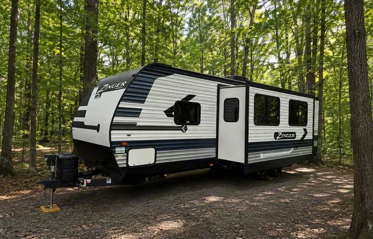 Enjoy this beautiful camper that provides an outdoor kitchen and outdoor shower!