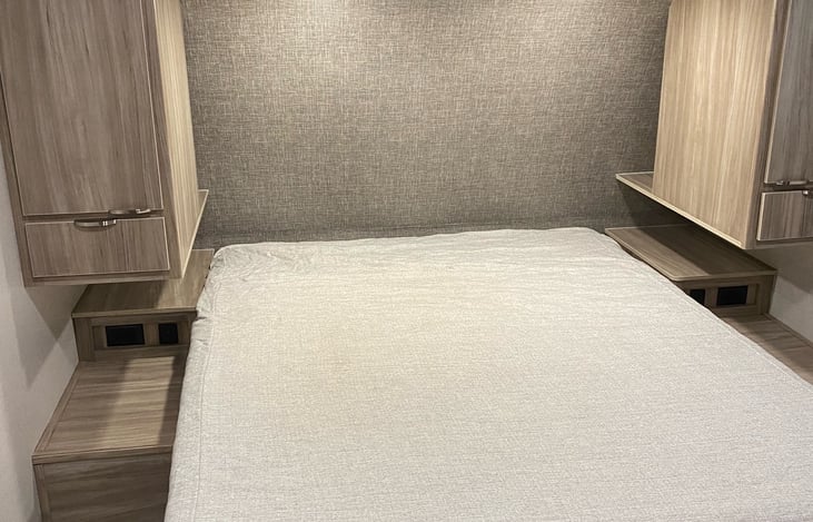 Queen size bed in bedroom.  Lots of storage all around.