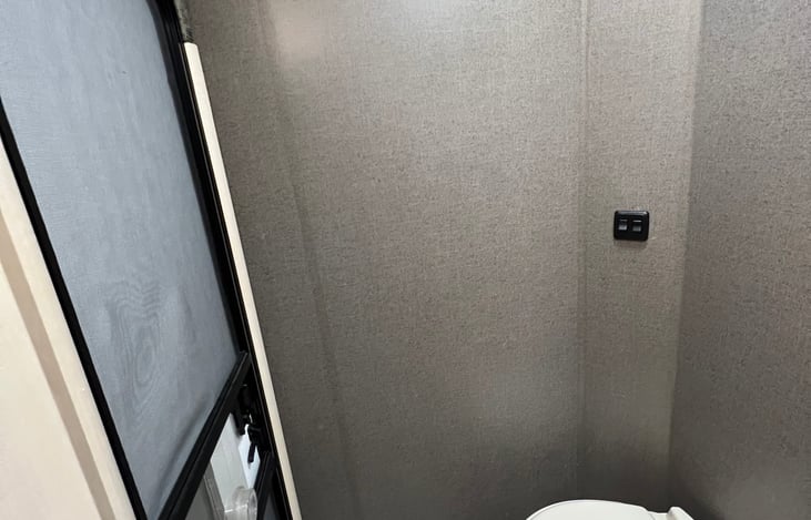 Towel hooks and porcelain toilet.