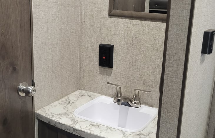 bathroom sink, separate from shower and toilet area.