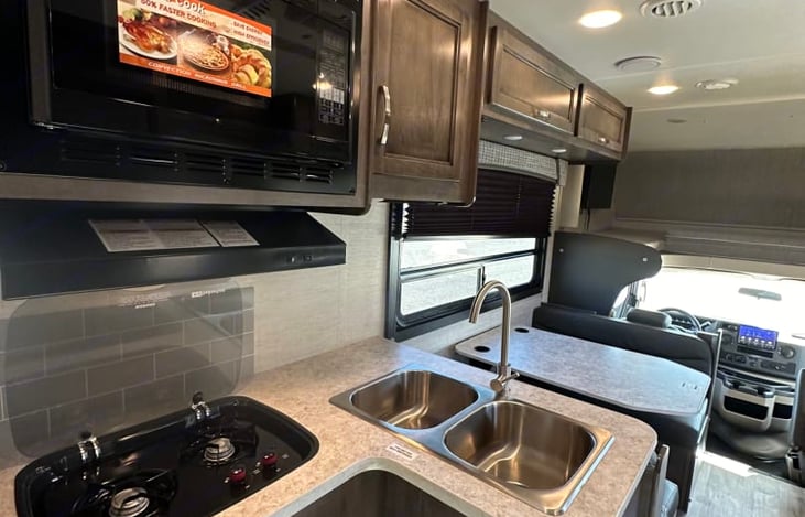 Convection microwave, two burner stove, and double basin sink allow you to feed the gang.