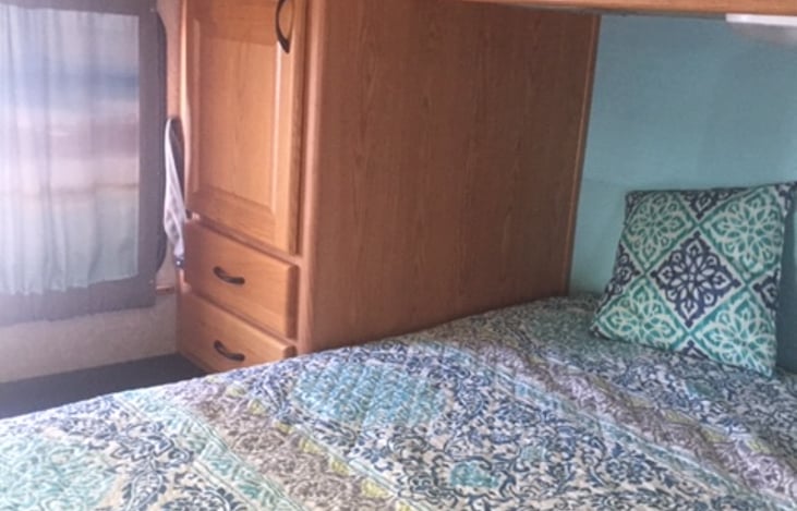 Master bedroom with linens passenger side