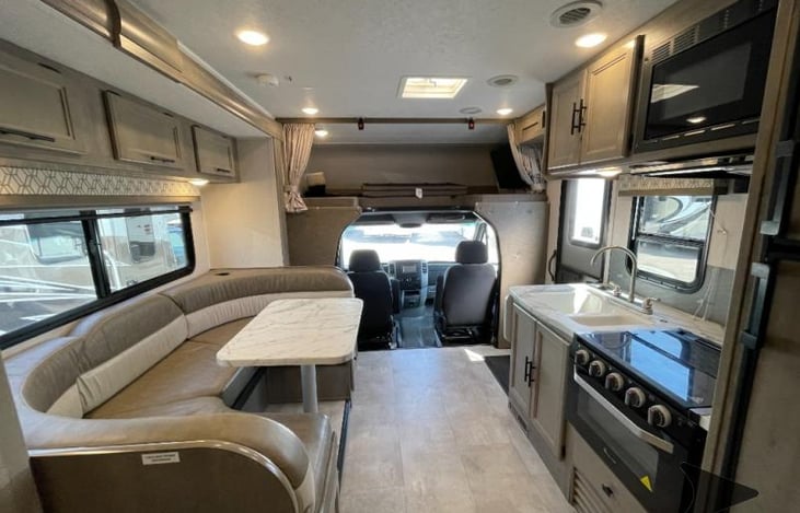The upper bunk has a net so nobody rolls out of bed, along with a Smart TV that swivels. Seating in the U-shaped booth, that converts for sleeping, along with seatbelts to fasten in Carseats.