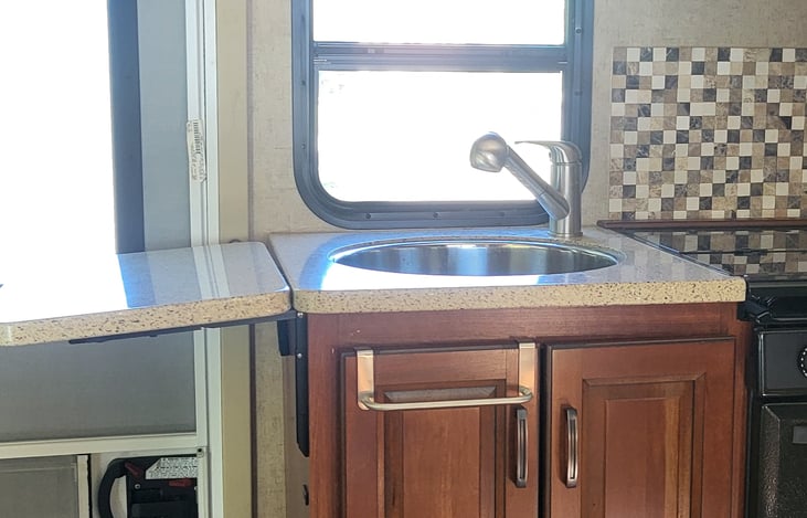 Kitchen sink with counter extension open