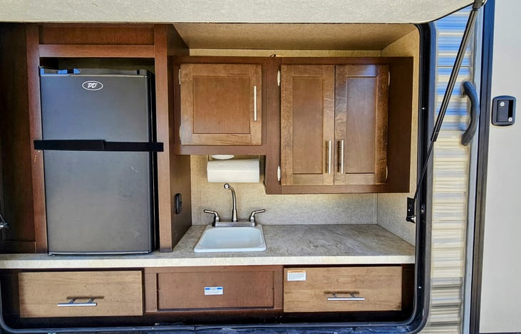 Exterior kitchen with beverage refrigerator and sink