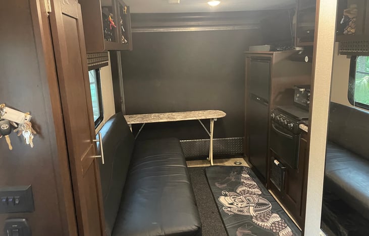 The table in back can be used inside or outside or folded and placed under the couch. We keep it at the end until dinner time and use it as extra shelf space.