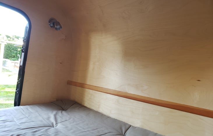 L side door, reading lamp, and front of queen mattress.