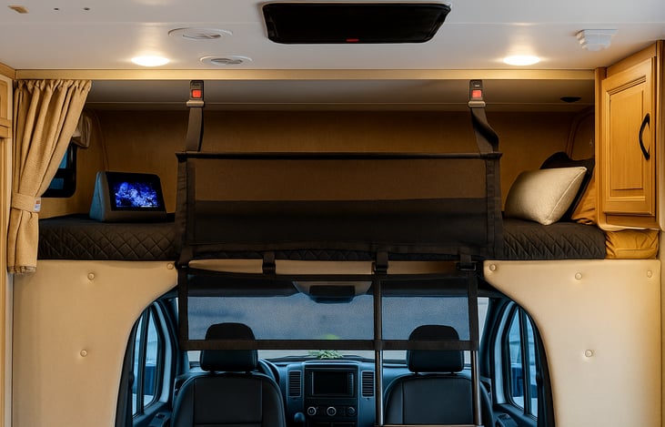 Overhead bunk with safety net, privacy curtain, and a small window by the feet. Perfect for two kids or one adult to sleep comfortably.