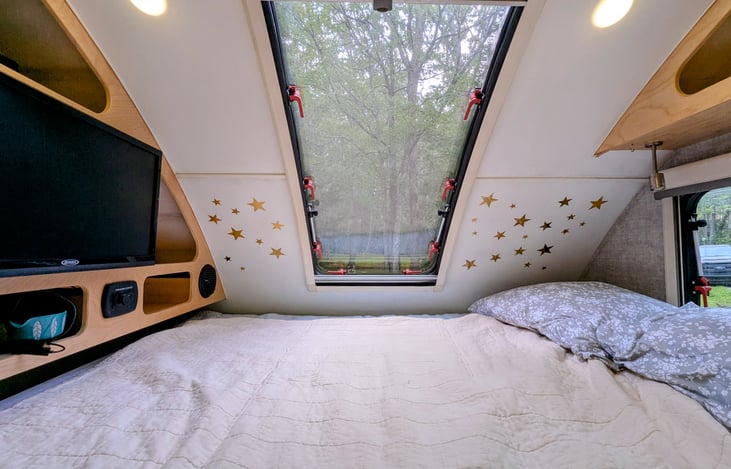 Cozy Queen bed nook with two windows, TV, stereo and storage cubbies will ensure you are comfortable and have everything you need for some rest and relaxation.