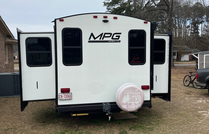 It has opposing slides which creates a larger living room area and in this area there are two recliners and a couch that let's out into a bed