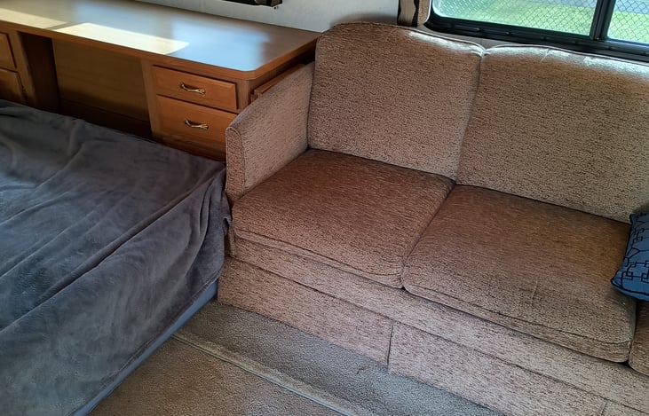 nice couch opens to a queen bed when parked