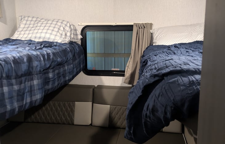 Bunk beds can tilt up for more space. Couch folds down into a queen sized bed