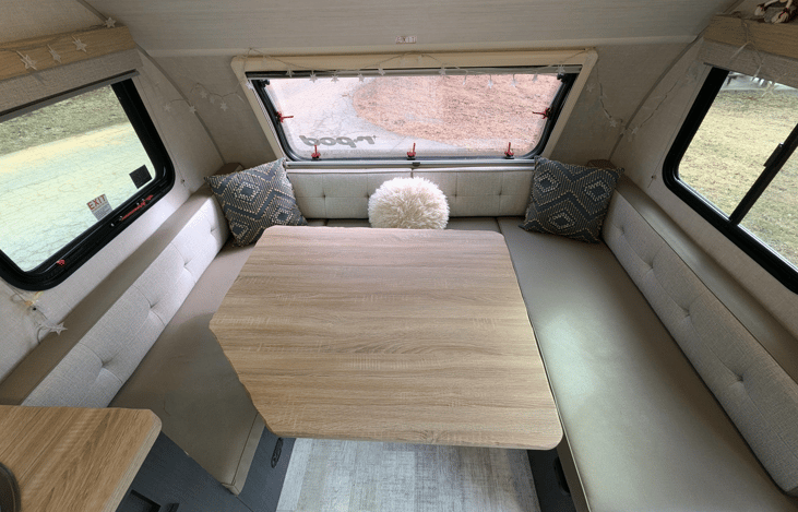 Cozy, modern and bright living area with well-equipped kitchen, TV, large dinette that converts to a bed, pop-out window and whimsical touches throughout.