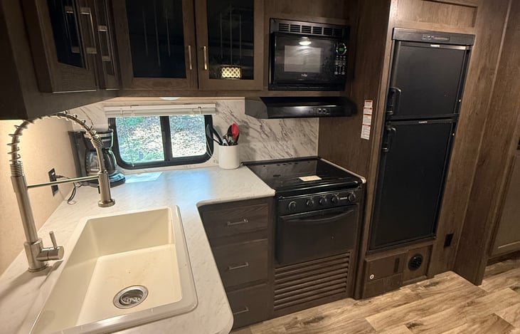 Kitchen with countertop and secure cupboards.