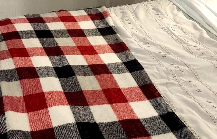 Master bed with extra throw blanket
