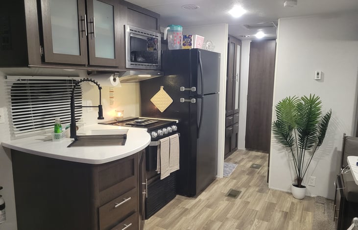 kitchen area again, dinette table on right beside couch across from stove.