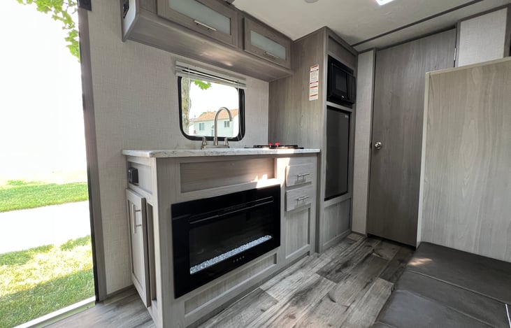 Kitchenette with storage and fireplace for cold nights