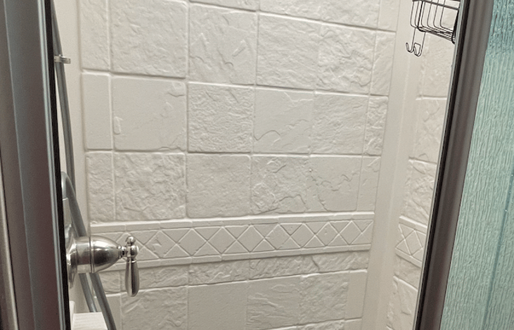 Shower. I'm able to stand fully at 5ft 9inches. :)