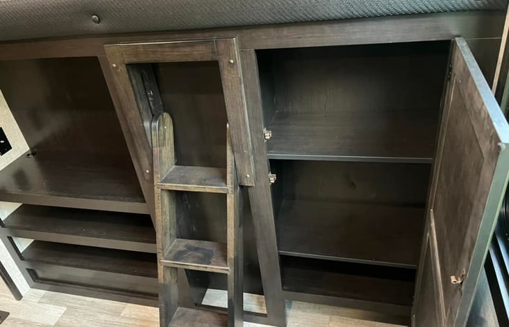 Cabinet storage & shelves in bunk house.