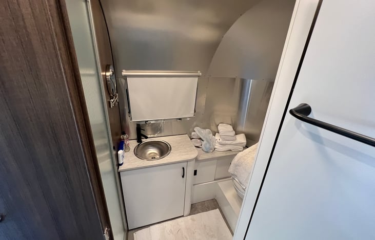 Bathroom with sink, toilet and shower.