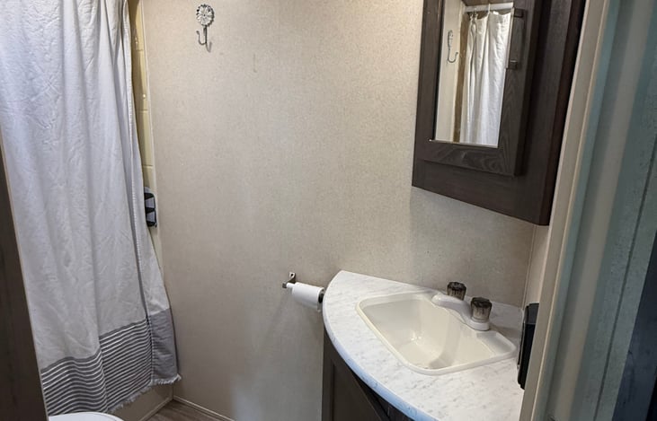 Bathroom with vanity mirror cabinet and under sink storage.