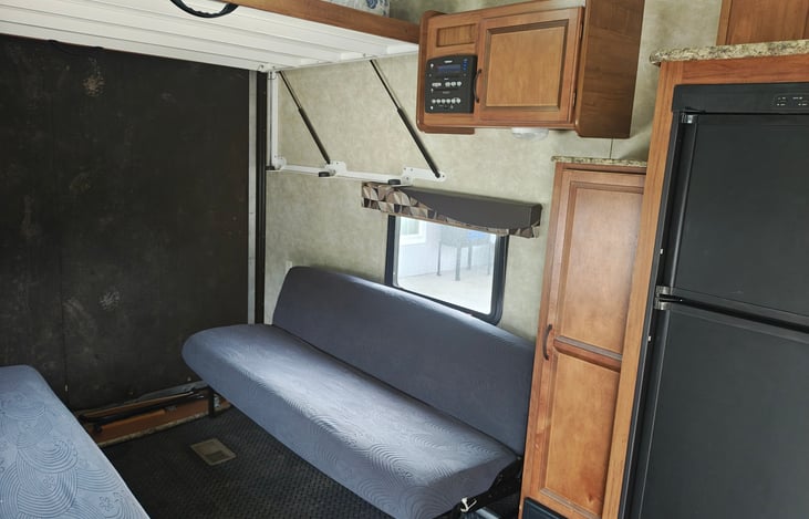 Queen bed above these sofas pulls down to provide even more sleeping room