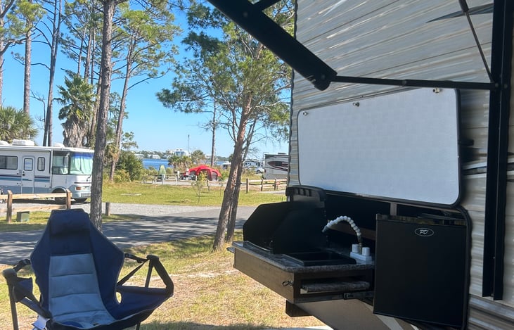 Two burner stove, small sink, and fridge for your favorite beverages.