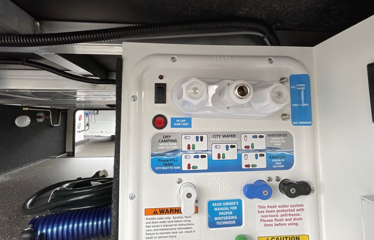 Close-up of water heater and water pump controls.