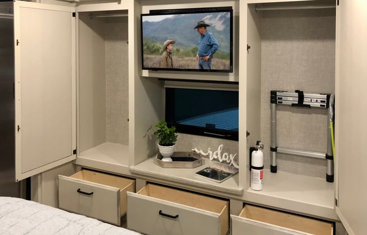 Main bedroom wardrobe closets. TV also hinges up to provide additional storage space behind the TV.