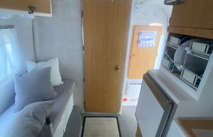 Casita wet bathroom view to door and closet storage to the right hand side.