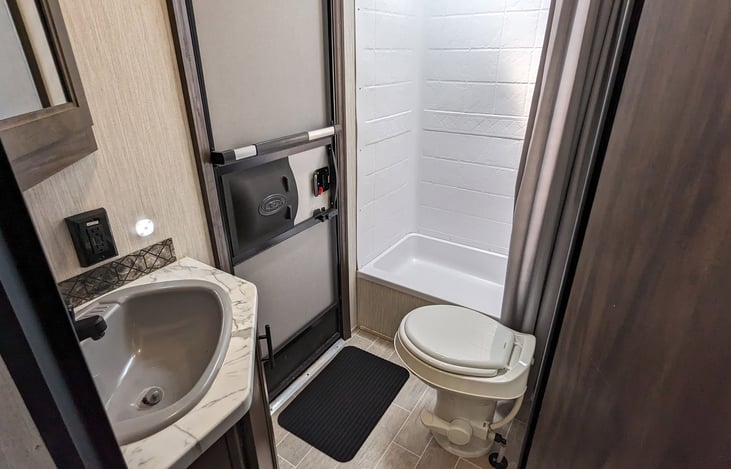 Dedicated exterior bathroom entrance complete with sink, toilet shower and short tub