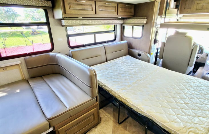 The dining table and pull out couch are ready for sleep.