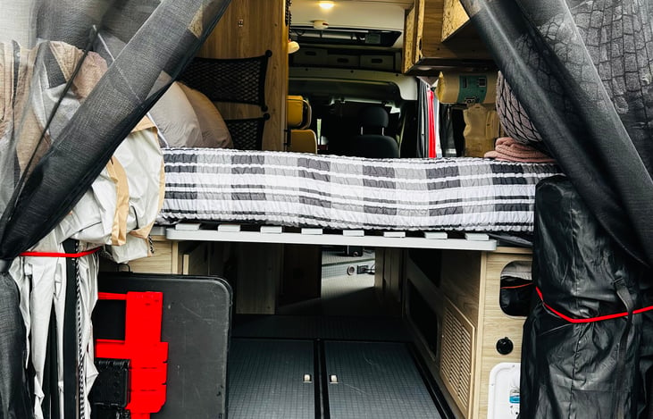 View into Clifford from the rear. Space under the bed and in the rear garage area for you luggage and gear.