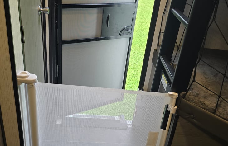 We are a baby/kid-friendly RV. This is a retractable baby gate for peace of mind so you dont have to worry about any kiddos falling out the door, also helps with little doggies running out.